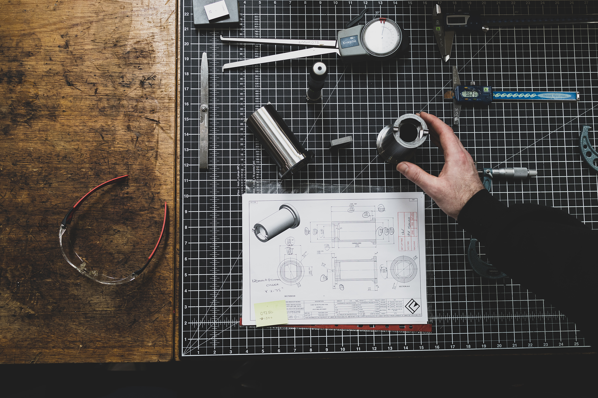 Tool Bench With Technical Drawings & Disassembled Tool